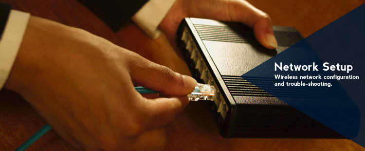 Picture of a man inserting a network cable into a router.